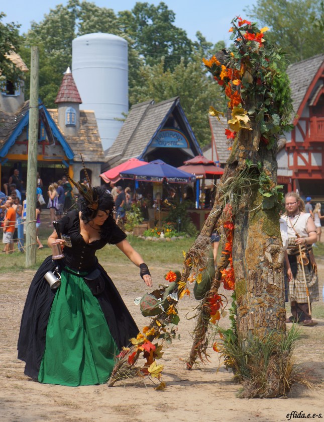 A lady giving coins to an ent at Michigan Renaissance Faire in Holly, Michigan. A lady giving coins to an ent at Michigan Renaissance Faire in Holly, Michigan.