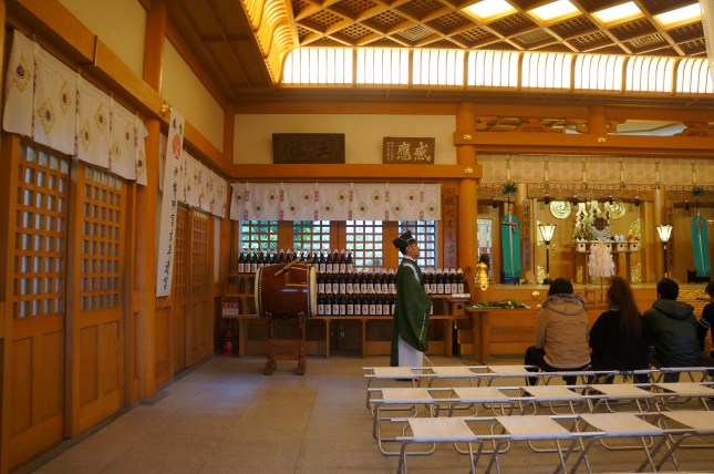 The priest inside the haiden at Futenma Shrine, Ginowan in Okinawa, Japan during hatsumode. The priest inside the haiden at Futenma Shrine, Ginowan in Okinawa, Japan during hatsumode.