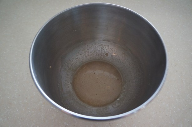 Mixed yeast and warm water for naan bread making.