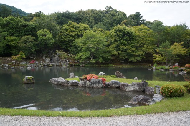 The garden featuring Sogen-chi pond (曹源地) surrounded by rocks, pine trees, maple trees and mountains at Tenryu-ji Temple in Arashiyama district in Kyoto, Japan. The garden featuring Sogen-chi pond (曹源地) surrounded by rocks, pine trees, maple trees and mountains at Tenryu-ji Temple in Arashiyama district in Kyoto, Japan.
