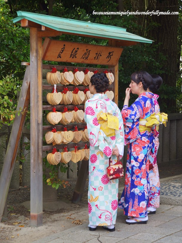 Beautiful Japanese women dressed in summer kimono trying to choose which ‘ema’ plaque to write their beauty wishes on at Utsukushi-gozensha 美御前社at Yasaka Shrine 八坂神社in Kyoto, Japan. Beautiful Japanese women dressed in summer kimono trying to choose which ‘ema’ plaque to write their beauty wishes on at Utsukushi-gozensha 美御前社at Yasaka Shrine 八坂神社in Kyoto, Japan.