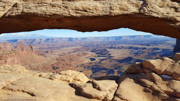The breathtaking view of the canyon as seen looking out from the Mesa Arch pothole in Canyonlands National Park in Moab, Utah. It is one of the most famous and most photographed arch in the park and is one of Microsoft's featured desktop background.