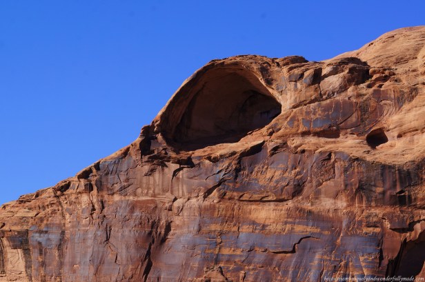 A carve on the sandstone wall which will come an arch in the future as seen from driving on the scenic 44 mile long Utah State Route 128, also famous as the Upper Colorado River Scenic Byway, along the Colorado River in Moab, Utab, USA.