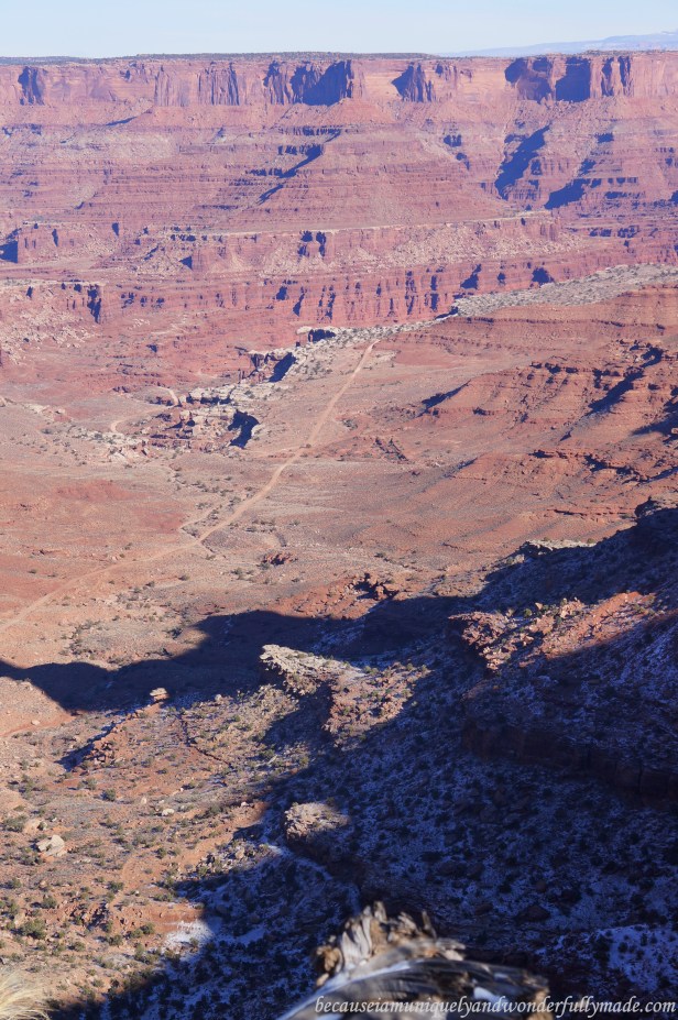 Looking down the tiny road on the Shafer Canyon floor for adventures with off-road vehicles at Shafer Canyon Overlook in Island in the Sky district, Canyonlands National Park in Moab, Utah. 