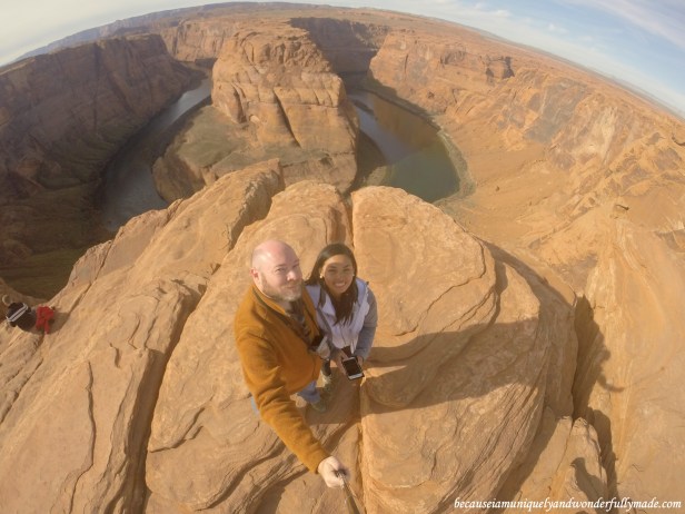 Standing at the rim of the Glen Canyon overlooking the Horseshoe Bend in Page, Arizona.
